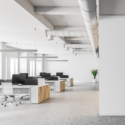 Modern office interior featuring desks, chairs, and natural light.