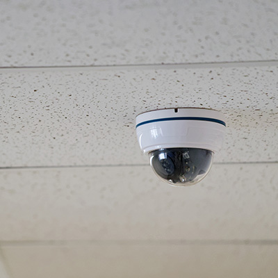 CCTV camera mounted on the ceiling in a commercial setting