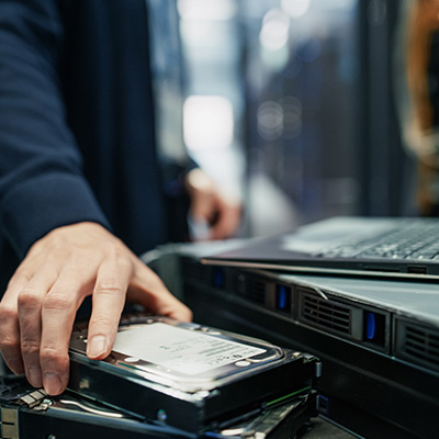 Technician installing a hard drive in a server rack at JMS Networks.
