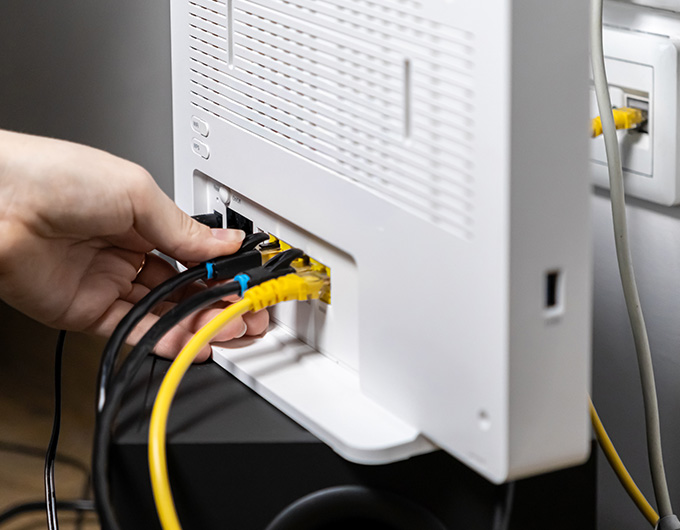 Connecting Ethernet cables to a network router for home network installation.