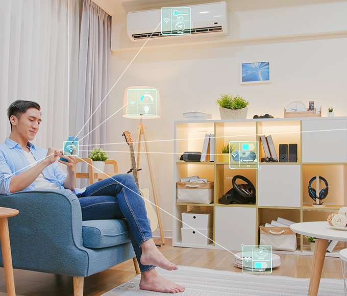 Man enjoying a smart home experience with connected devices in a modern living room.