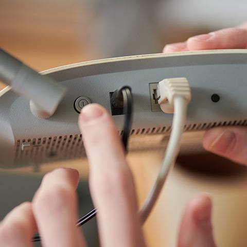 Connecting cables to a network device for installation.