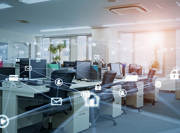 Office space with multiple computer workstations and digital connectivity icons.