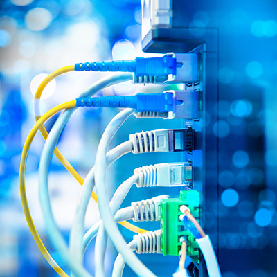 Structured cabling with copper and fibre connectors in a professional installation setting.