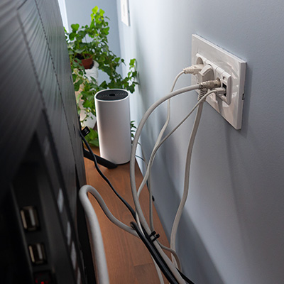 Structured cabling installation with multiple connections at a wall outlet in a residential setting.