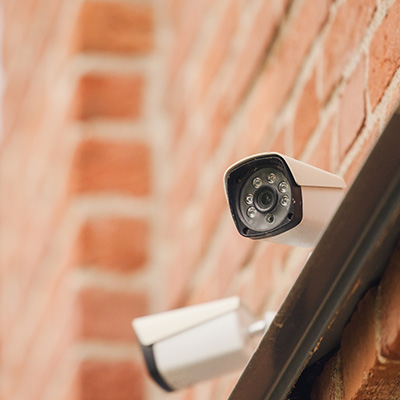 CCTV camera mounted on a brick wall for security surveillance.