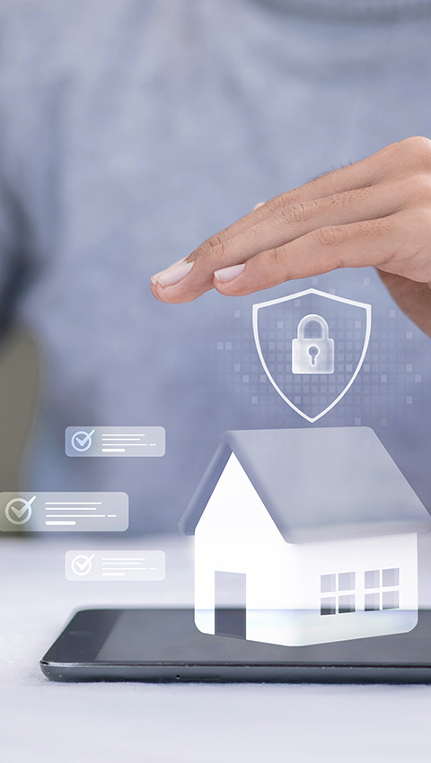 Hand hovering above a digital house icon representing security and home protection.