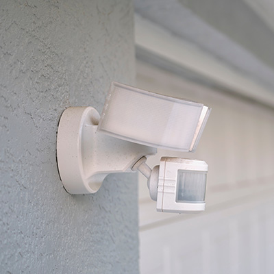 Residential motion sensor alarm system mounted on a wall.