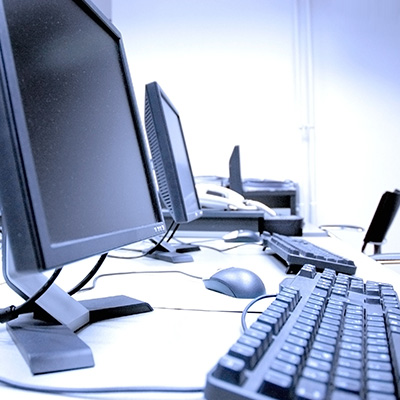 Workstation setup with monitors and keyboard for IT equipment deployment.